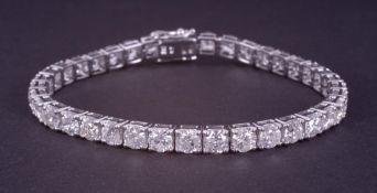 An 18ct white gold line bracelet set with approx. 11.60 carats of round brilliant cut diamonds,