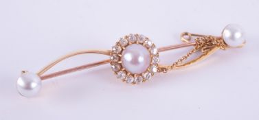 A yellow gold (not hallmarked or tested) bar brooch set with three cultured pearls, two 5.6mm and