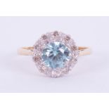 An 18ct yellow & white gold cluster ring set with a central round cut blue zircon, approx. 1.00