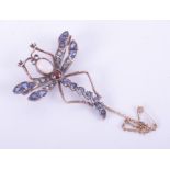 A rose & white gold (not hallmarked or tested) dragonfly brooch with a yellow gold safety chain, set