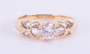 An 18ct yellow gold ring set with a central round brilliant cut diamond, approx. 0.46 carats, colour