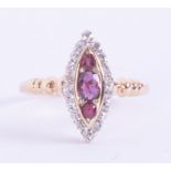 An antique 18ct yellow gold marquise shaped ring set with three oval cut rubies surrounded by old