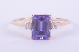 A 14ct yellow gold ring set with a central rectangular cut Tanzanite, 1.63 carats with two small