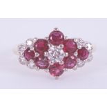 An 18ct yellow & white gold cluster style ring set with a mixture of round cut rubies, approx. total