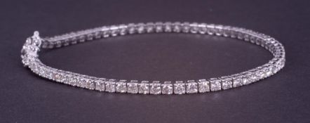 An 18ct white gold line bracelet set with approx. 3.25 carats of round brilliant cut diamonds,