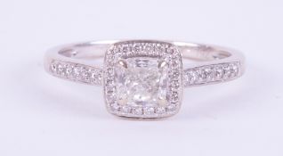 An 18ct white gold ring set with a central princess cut diamonds, approx. 0.50 carats, colour H-