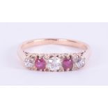 An 18ct rose gold five stone ring set with three old round cut diamonds, total weight approx. 0.37