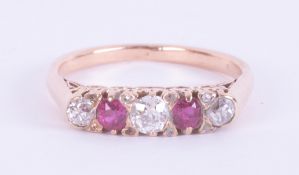An 18ct rose gold five stone ring set with three old round cut diamonds, total weight approx. 0.37