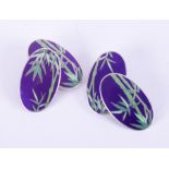 A pair of oval silver & enamel cufflinks with a bamboo design, approx. 1.9cm length x 1cm width,