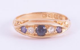 An 18ct yellow gold five stone ring set with three round cut sapphires & two old round cut diamonds,