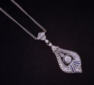An ornate 18ct white gold (stamped 750) pendant & chain in an Art Deco filigree style, the
