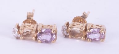 9ct yellow gold stud earrings set with oval cut pale yellow & pink topaz? & two small round diamonds