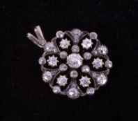 An Edwardian gold (not hallmarked or tested) flower style pendant set with old round cut diamonds,