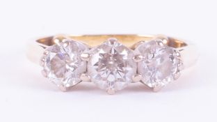 An 18ct yellow & white gold three stone ring set with three round brilliant cut diamonds, total