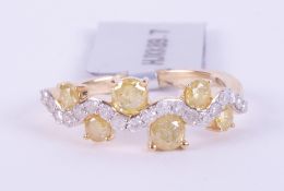 A 9ct yellow gold wave design ring set with 0.83 carats of round cut natural yellow diamonds (stated