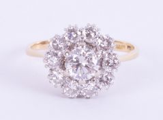 An impressive 18ct yellow & white gold flower cluster ring set centrally with approx. 0.80 carats of