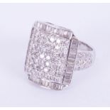 An ornate 18ct white gold square shaped cluster ring set with a mixture of round brilliant cut