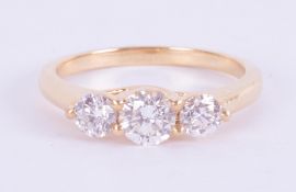 An 18ct yellow gold three stone trilogy ring set with three round brilliant cut diamonds, total