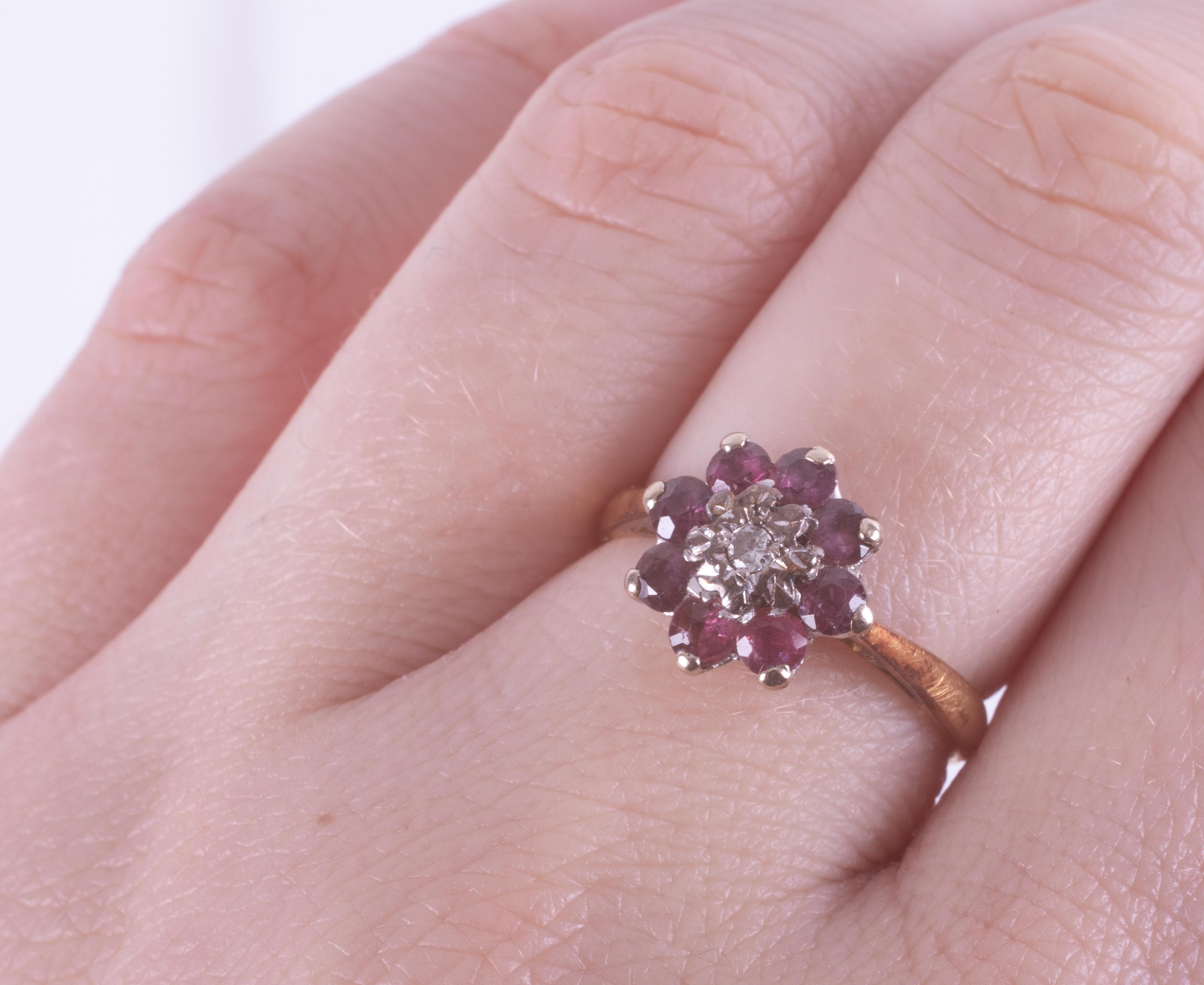 An 18ct yellow gold cluster ring set with a small central round cut diamond, surrounded by round cut - Image 2 of 2