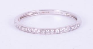 A fine 18ct white gold half eternity ring set with 0.20 carats of round brilliant cut diamonds, 1.