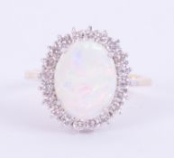 An impressive 18ct yellow & white gold cluster ring set with a central oval cut cabochon white