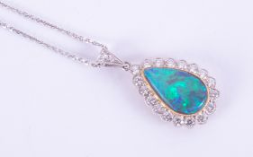 An 18ct white & yellow gold pendant set with a pear shaped black opal, measuring approx. 14.5mm x