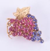 An 18ct yellow gold grape brooch set with round cabochon cut rubies & sapphires, with pin & safety