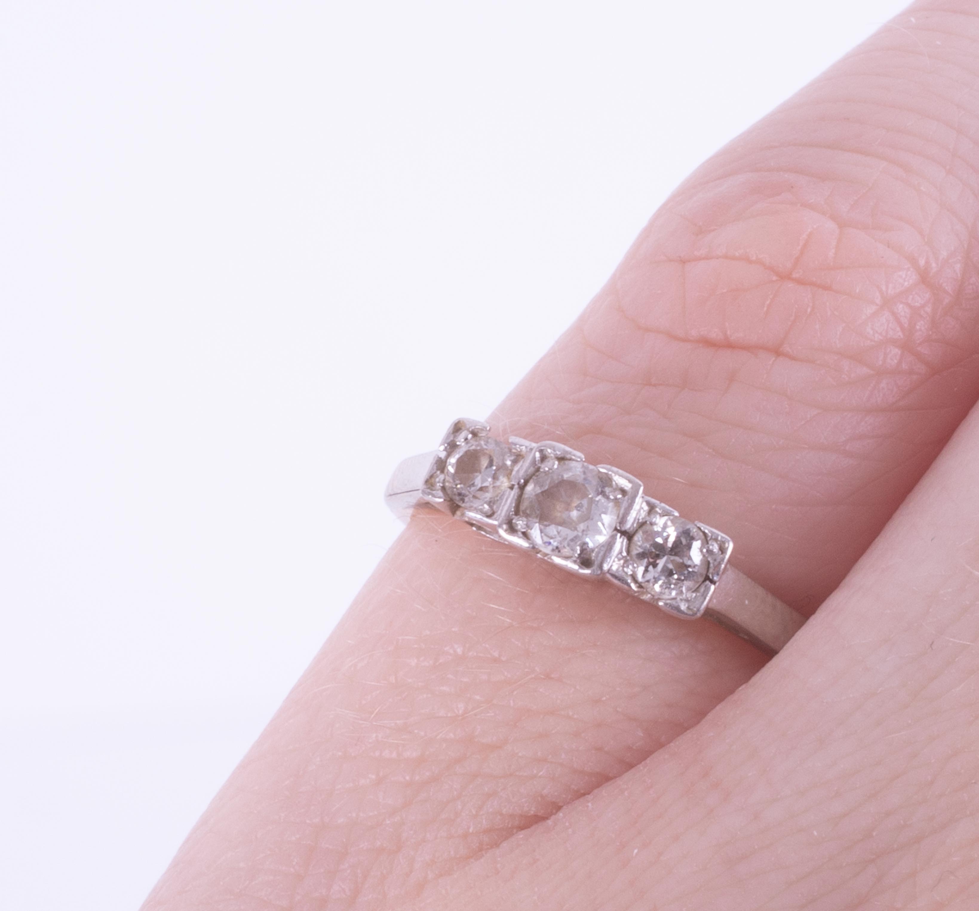 An 18ct yellow & white gold three stone ring set with three round cut diamonds, approx. total - Image 2 of 2