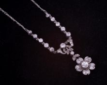 A fine Edwardian white gold (no hallmark & not tested) ornate flower & bow design necklace set