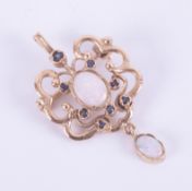 A 9ct yellow gold ornate open design pendant/brooch set with two oval cabochon cut white opals and