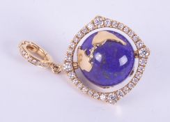 An 18ct yellow gold pendant set with a spinning lapis lazuli & gold 'World' surrounded by small