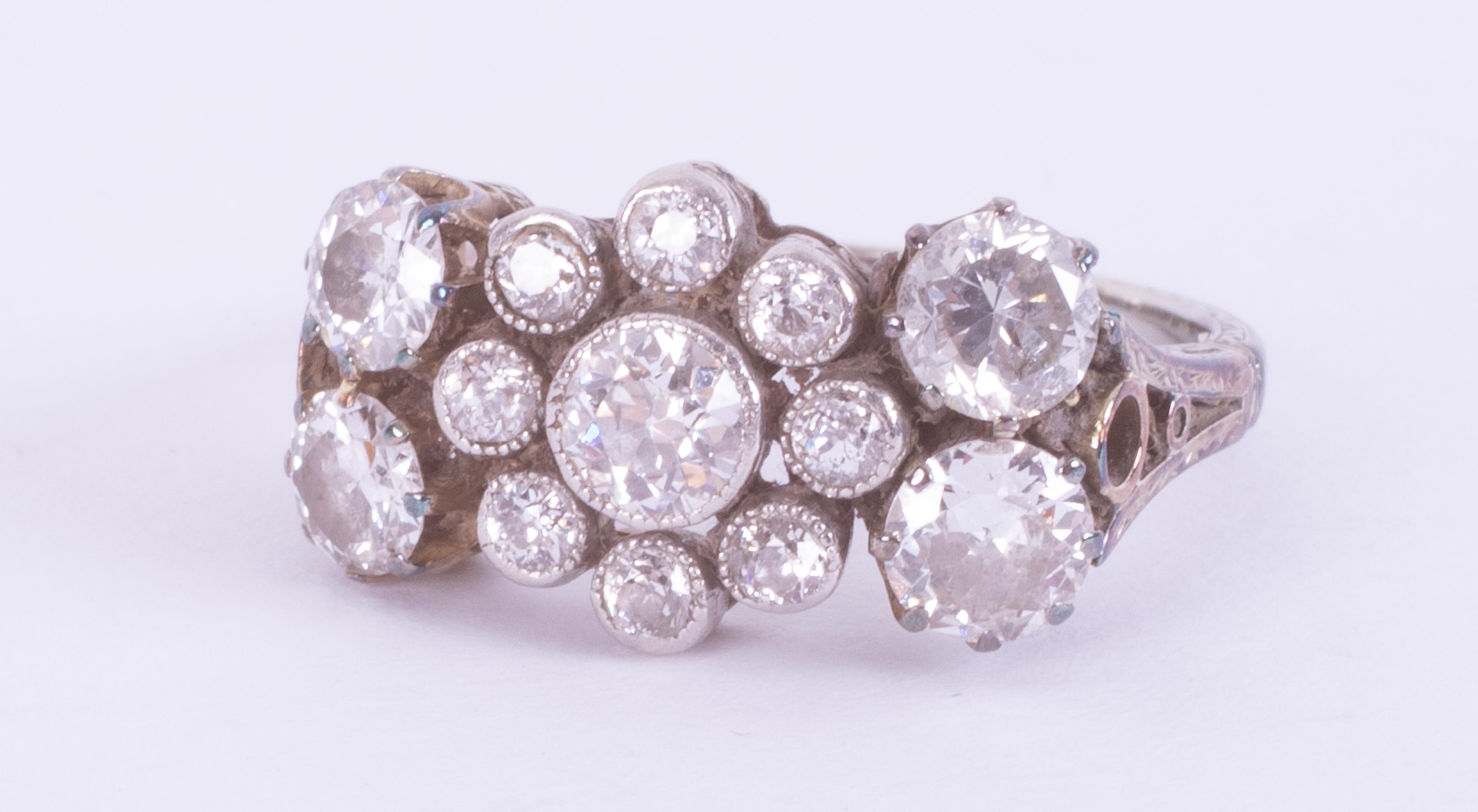 An Edwardian 18ct gold & platinum engraved multi-stone ring set with old round cut diamonds, total