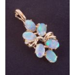 A 14k yellow gold pendant set with six oval cabochon cut white opals displaying good colour play,