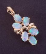 A 14k yellow gold pendant set with six oval cabochon cut white opals displaying good colour play,