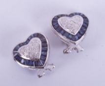 A pair of 18ct white gold heart shaped earrings set with sapphires in a mixture of cuts and small