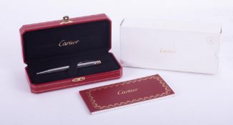 Cartier, a ballpoint pen by Cartier Stylo Bille Trini De Cart Godron Vertical with palladium finish,