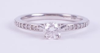 A fine platinum ring set with a central round brilliant cut diamond, 0.44 carats, colour D