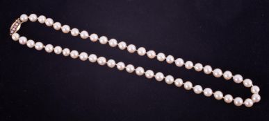 A string of knotted cultured white pearls with a creamy lustre, approx. average size 7.5mm, strung