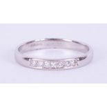 A platinum half eternity band set with seven round brilliant cut diamonds, total weight approx. 0.21