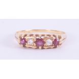 An 18ct yellow gold five stone ring set with three round cut rubies and two round cut diamonds, 2.