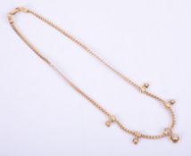 An 18ct yellow gold necklace with a flat curb style chain and rubover drops set with round brilliant