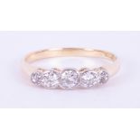 An 18ct yellow & white gold five stone rub over ring set with five round brilliant cut diamonds,