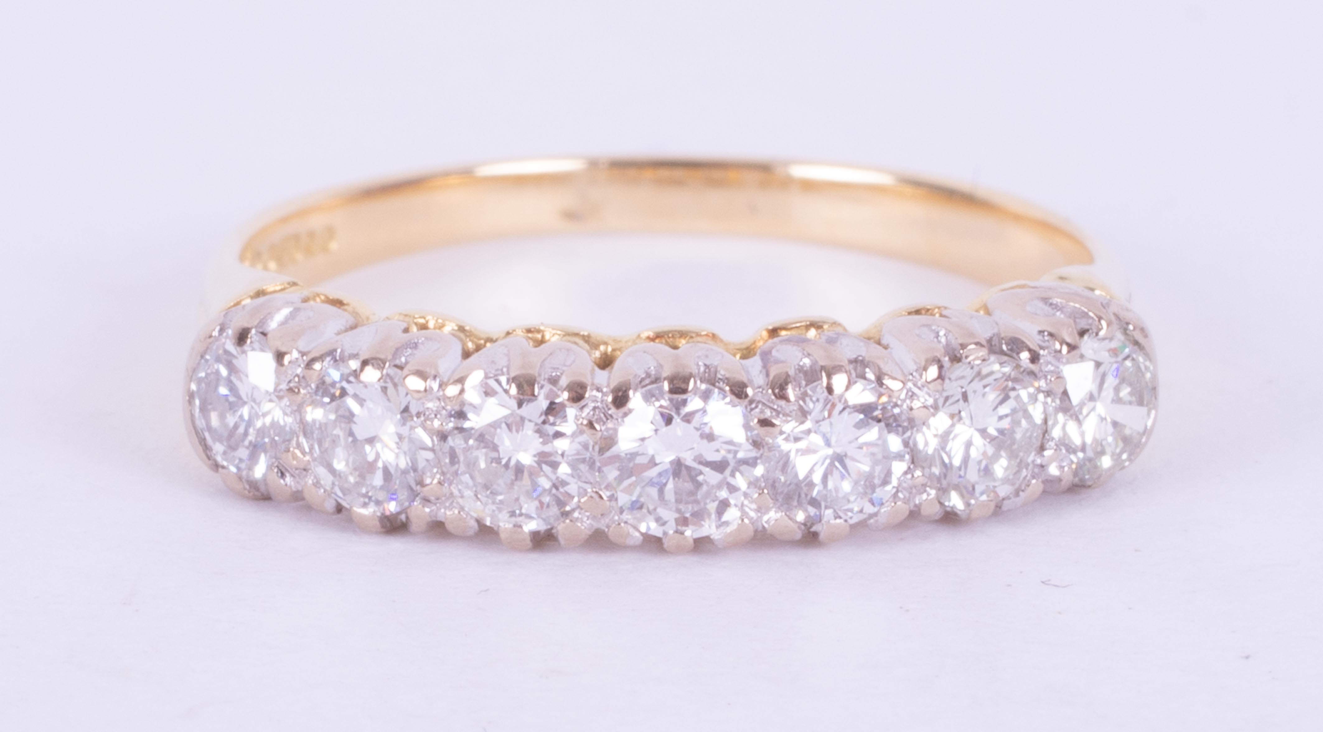 An 18ct yellow & white gold seven stone ring set with round brilliant cut diamonds, total weight