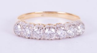 An 18ct yellow & white gold seven stone ring set with round brilliant cut diamonds, total weight