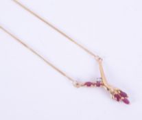 A 9ct yellow gold necklace set with five marquise shaped rubies and a small round brilliant cut
