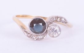 An antique 18ct yellow & white gold twist style ring set with a round cut sapphire and an older
