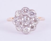 An 18ct yellow & white gold daisy cluster ring of the Art Deco period set with approx. just over 2.