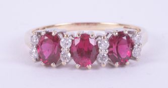 A 9ct yellow & white gold ring set with three oval rubies, total weight approx. 0.99 carats