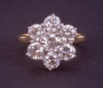 An impressive 18ct yellow & white gold flower cluster ring set with round brilliant cut diamonds,