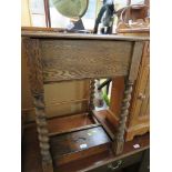 STAINED OAK SQUARE SIDE TABLE WITH LIFT UP STORAGE COMPARTMENT STANDING ON SPIRAL TURNED SUPPORTS.